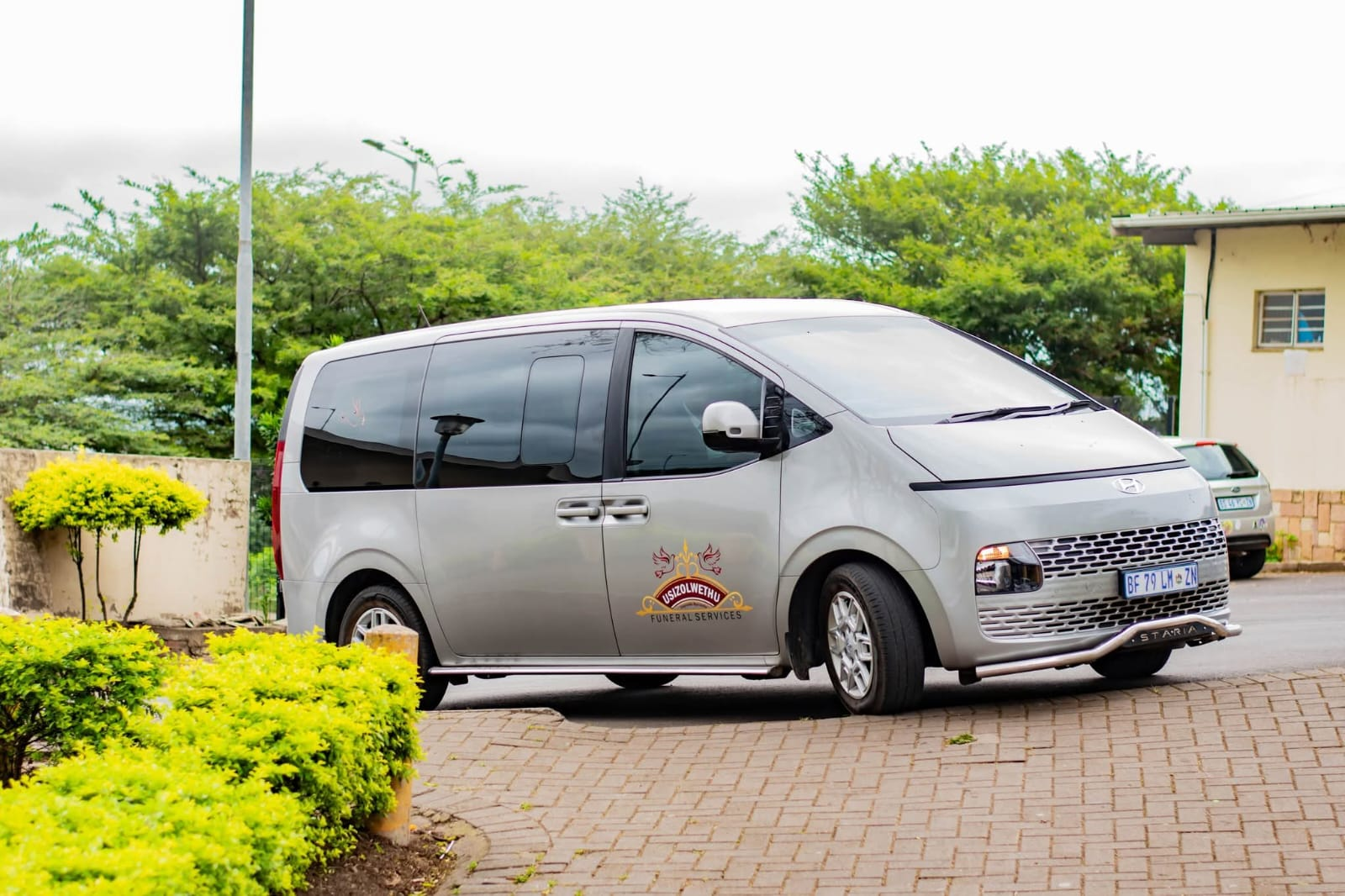 Silver Usizolwethu-branded Hyundai Staria minivan parked outdoors