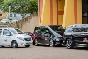 Mixed fleet of white and black branded vehicles outside a branch