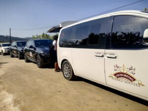 White branded Usizolwethu funeral services van with fleet vehicles
